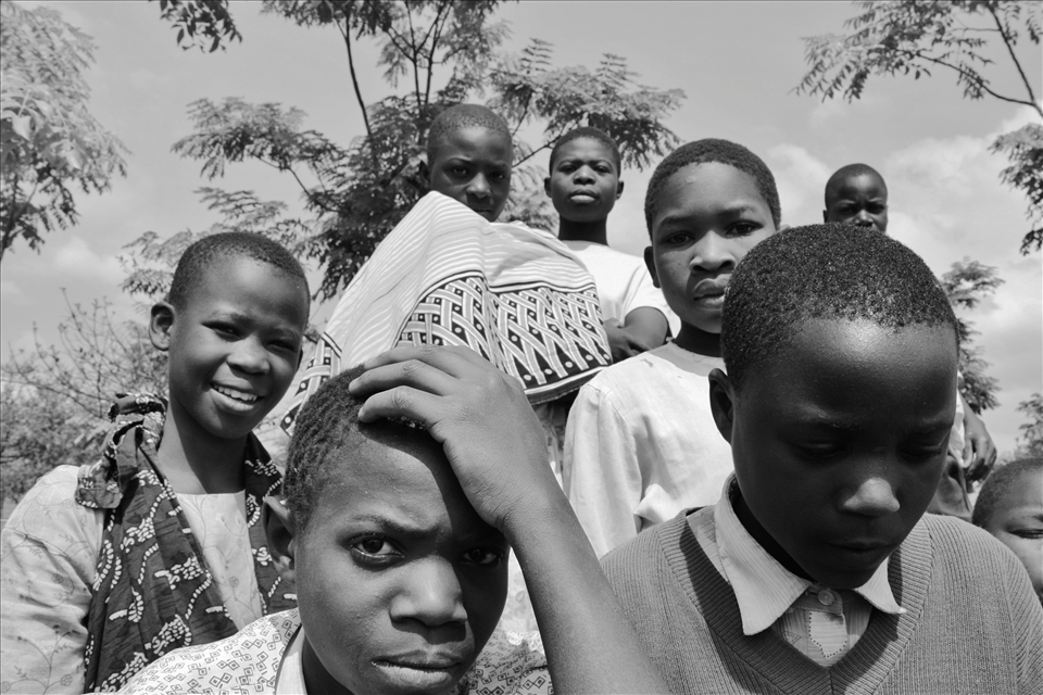 Wary. Day one meeting the children at Wangama primary school. They aren't very comfortable with us around, after walking miles to get to school they sit and stand and wait behind us, while we discuss classroom renovation plans with their teachers.