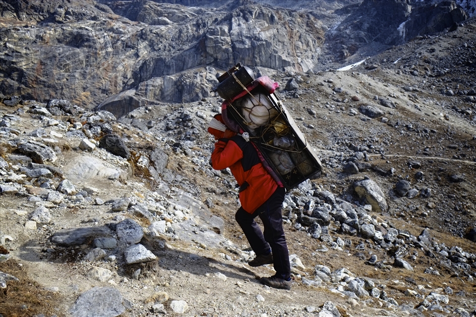 While you struggle for breath, a whistling sherpa breezes past carrying half a kitchen on his back