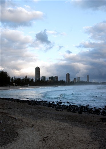 On the beach as the dark storm clouds roll in.