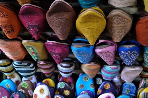 Racks of shoes and other leather good products hung from the various shops surrounding the tannery and within the medina.