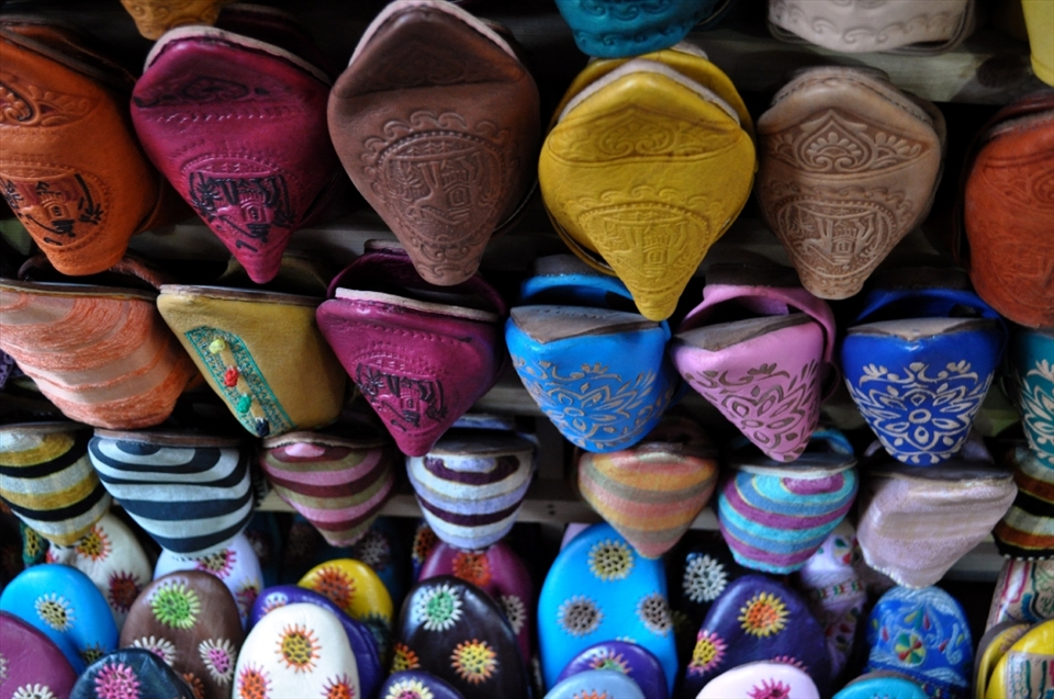Racks of shoes and other leather good products hung from the various shops surrounding the tannery and within the medina.