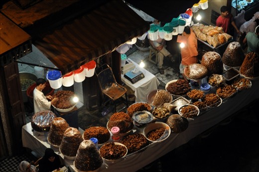 One of the many stands selling sweet delicious honey treats. The treats were covered in a plastic wrap to attempt to ward off the constant visitors of bees.