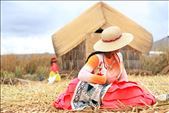 Native woman on Santa Maria of the floating islands of Uros, Lake Titicaca. Women here design craft items to sell to tourists. This particular woman was weaving an interpretation of Pachamama or 