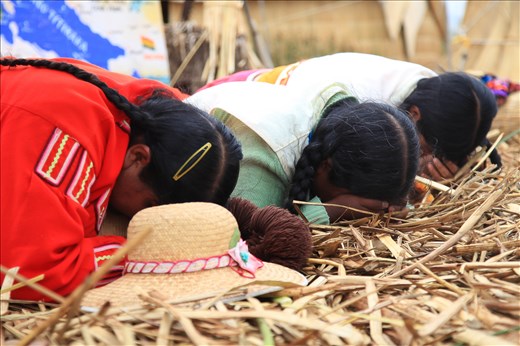 The women of Santa Maria receiving a blessing from a local shaman. Spirituality is an extremely important part of life on Uros and it is infused with native customs and traditions.