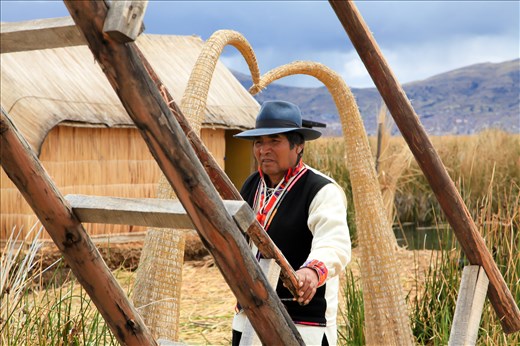 The elected leader of Santa Maria, guarding the watchtower which is made almost completely of totora reeds.