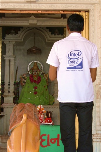 Science Surrenders - 
Ahmedabad has the blend of old values and new culture. People are very religious, maybe superstitious too, but the education in that city is one of the best in the country. Many of the country's best universities are located there. 
Tradition is tradition though. 
Managed to capture this as I saw a man opening a temple, the city streets are lined with little temples.
