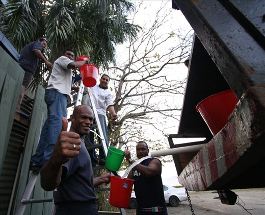 Staff manual fill the water supply for hotel in Suva following cyclone