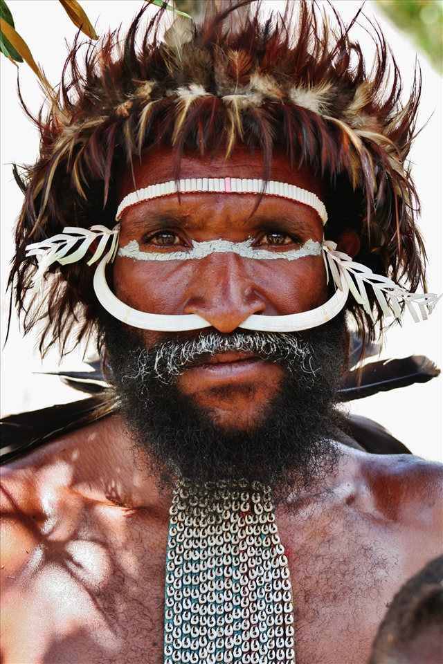 A Papua man in his full warrior paint for tribal war dance.