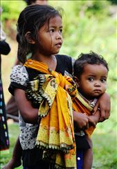 A young girl protecting her little sister by playing 