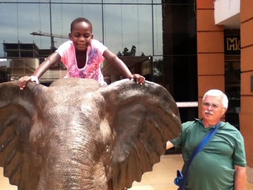 Up on the elephant outside the entrance to the Nakumatt (Kampala's version of Walmart)