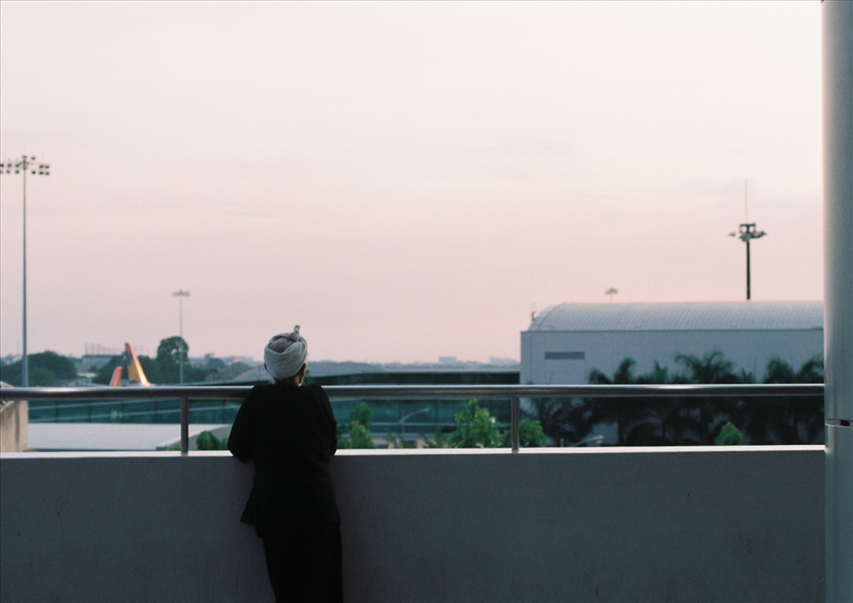 An old man at the airport watching sunset, by 35mm film