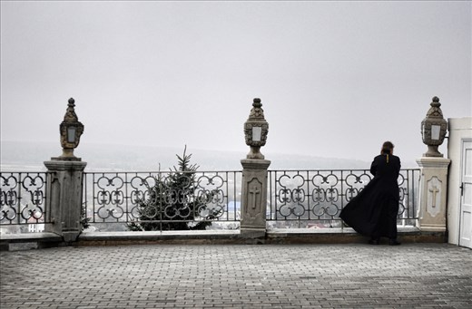 Priest of the religious complex went to have some cold air in misty morning