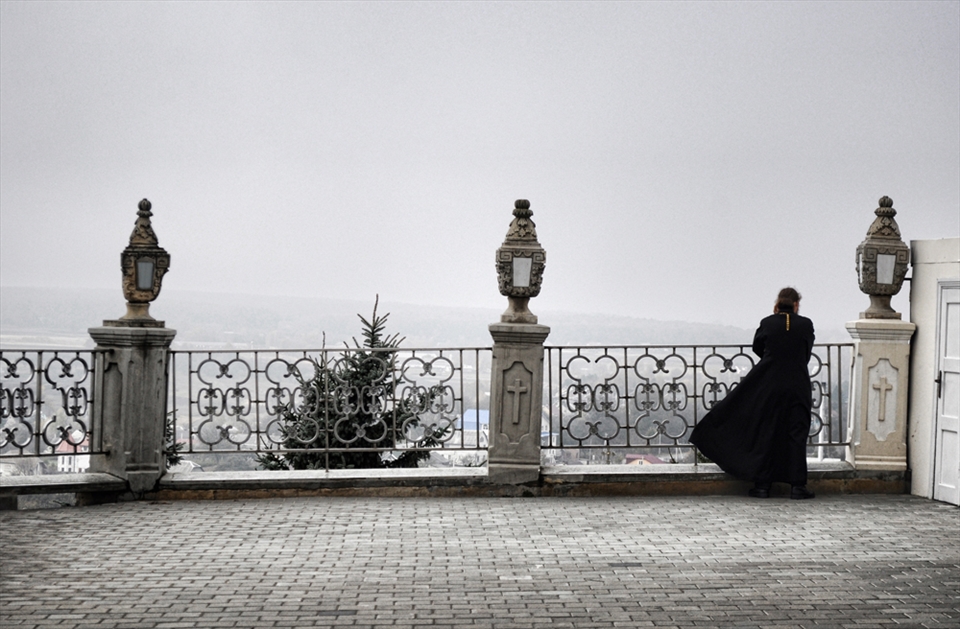 Priest of the religious complex went to have some cold air in misty morning