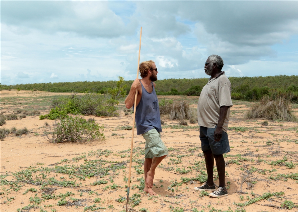 Simon, a remote area nurse, bumps into Banthay, a traditional owner of the land,  on the sand dunes that divide entangled mangroves and the ocean at Ganpura.