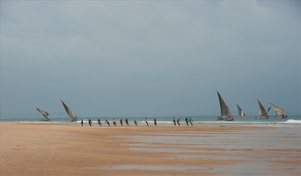 Hauling. 14 boys to haul in the fish, with the waves, until reaches beach.