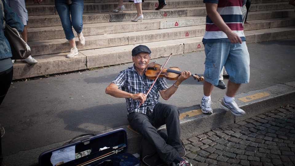 A street artist plays on the steps outside Sacre-Coeur