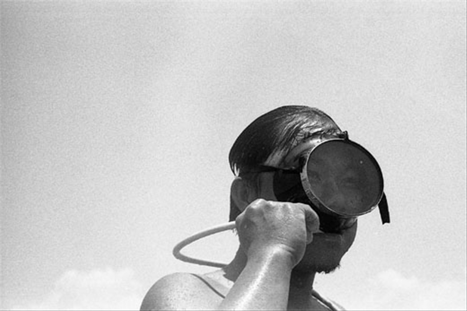 A diver clears his breathing tube.
