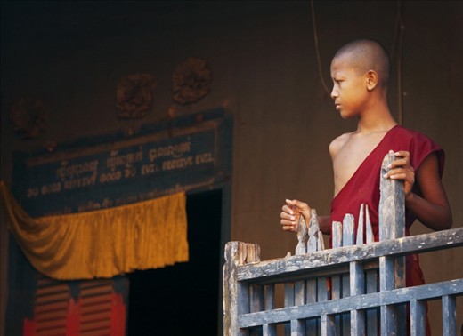 A young monk tied to his village for spiritual belief and religion.