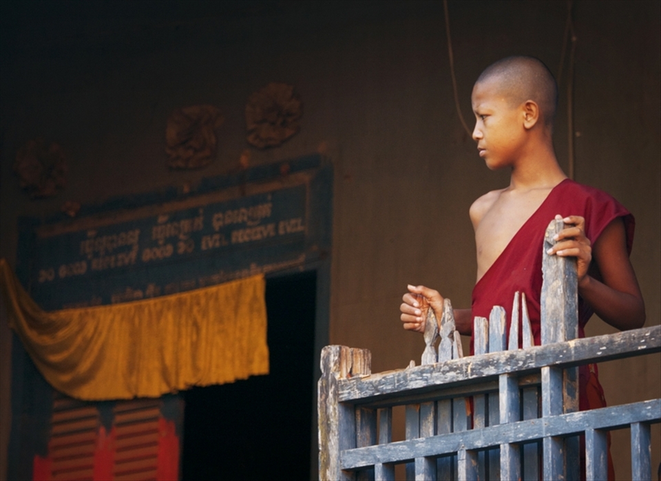 A young monk tied to his village for spiritual belief and religion.