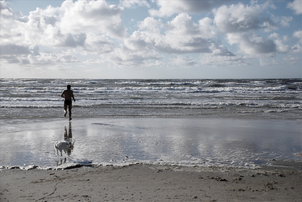 The ocean temperature rarely reach above 15 degrees Celsius during the summer, but that's nothing that prevent lively people from taking a trip to the beach at Jammerbugten in Northern Denmark. Excitement showing as the water gets barely warm enough to swim in, though still not warm enough for the accompanying loyal dog Lou that jumps in desperation to avoid the ice cold water.