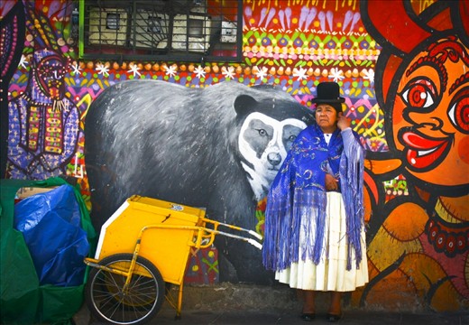 Sojourn :
In spite of having a difficult life, Bolivians make time for their families. She was waiting against this perfect background of a wall for a bus when I sneaked this picture. Later, it turned out we were both going to take the same bus for a long journey. After I put her at ease with my Spanish, she told me her name was Ava and she had taken a few days off to go to Sucre to take care of her widowed sister who had just suffered a heart attack. She was a very well-spoken and dignified woman.
NB: For continuation of my story, please take this as photo # 4. (I could not change the order of the photos)
