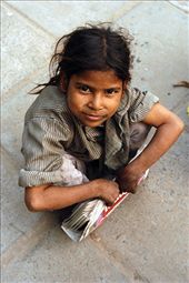 A young girl rests in New Delhi whilst selling newspapers.: by njrussell, Views[268]