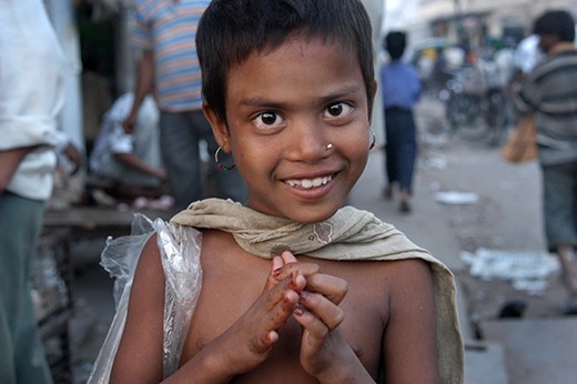A young girl smiles despite makes a living collecting rubbish in Jaipur.