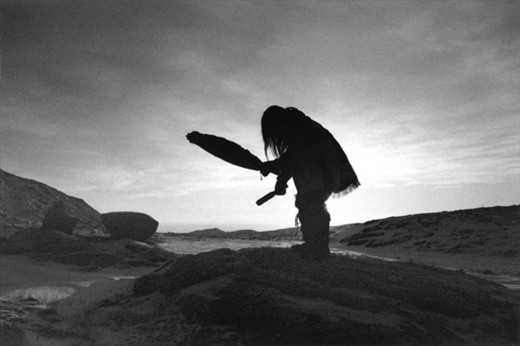 Artist and Drum Dancer Mathew Nuqingaq drums and sings on the winter tundra. (temp: -30degC)