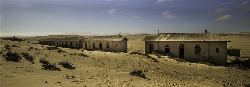 The  former Namibian diamond mining town of Kolmanskop being reclaimed by the desert