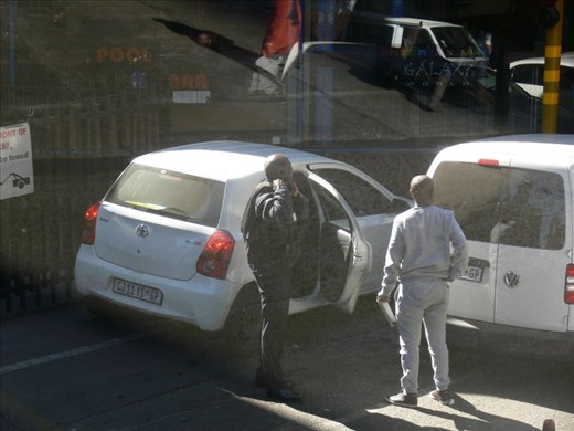Securtiy guard putting on a bullet proof jacket before going to work