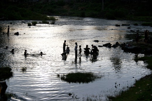 After working in the fields all day the village goes down to the river to bath. 