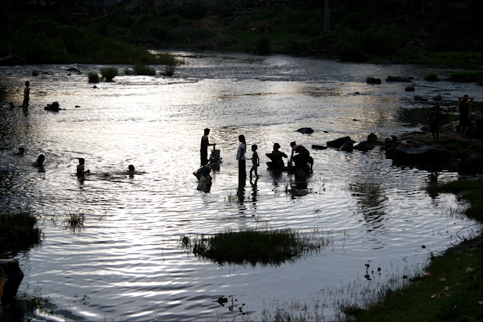 After working in the fields all day the village goes down to the river to bath. 