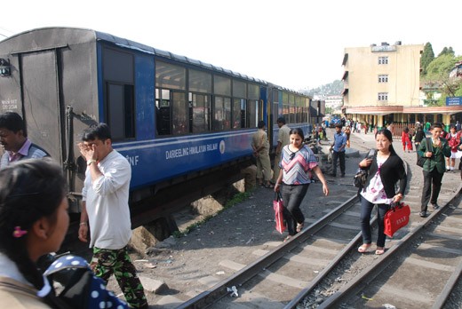 PEOPLE ARE PASSING OVER THE RAILWAY TRACK