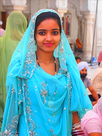 A Beautiful Stranger. A shy girl smiles for the camera and makes a visitor feel truely welcome