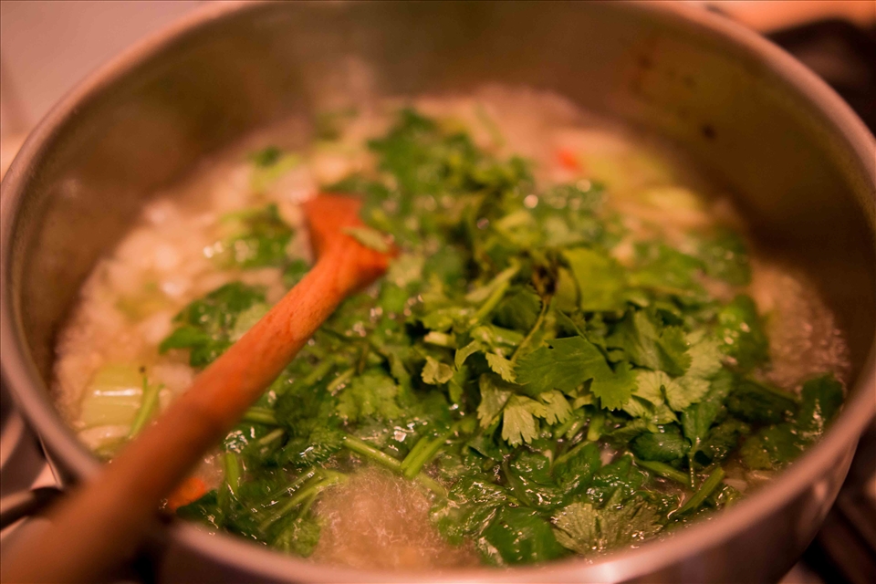 Add stock to the base ingredients then fresh coriander