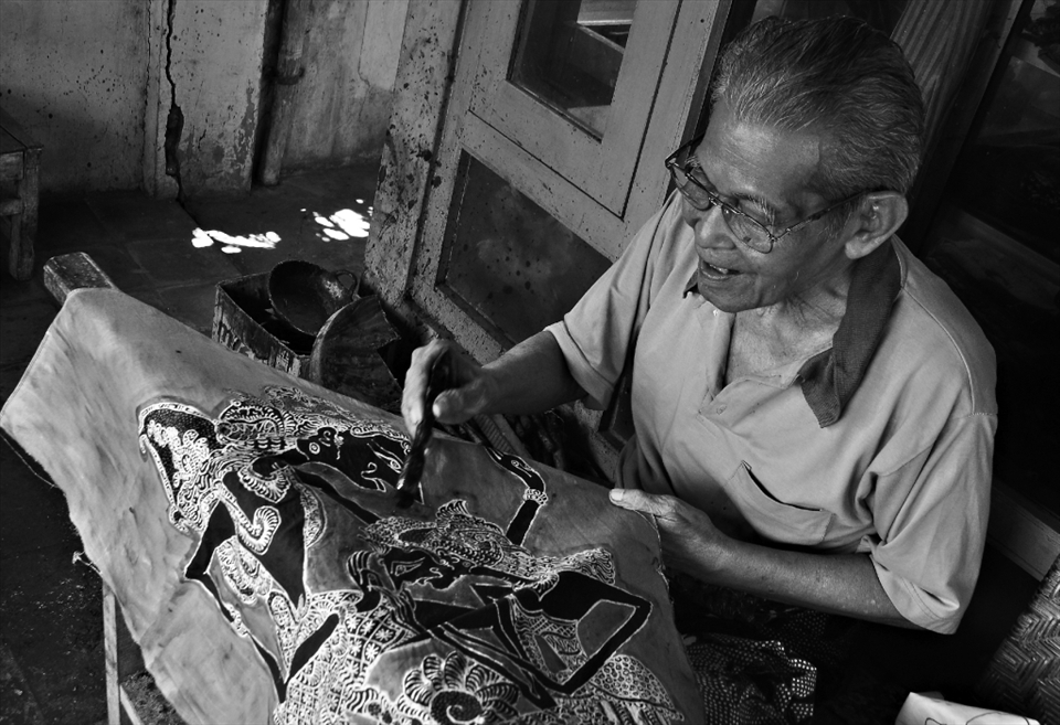 An old man demonstrates batik painting technique,this batik will be sold to the tourists who visit Taman Sari. Batik is Indonesia's traditional cloth, each batik has different meaning depends on its patterns.