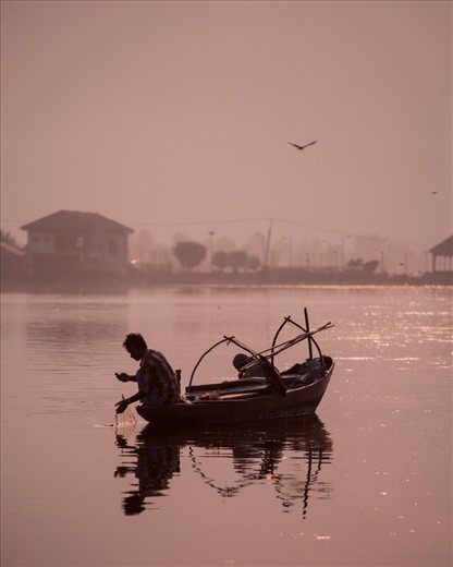 A Fishermen on the Dhal Lake, waiting for his early morning catch.