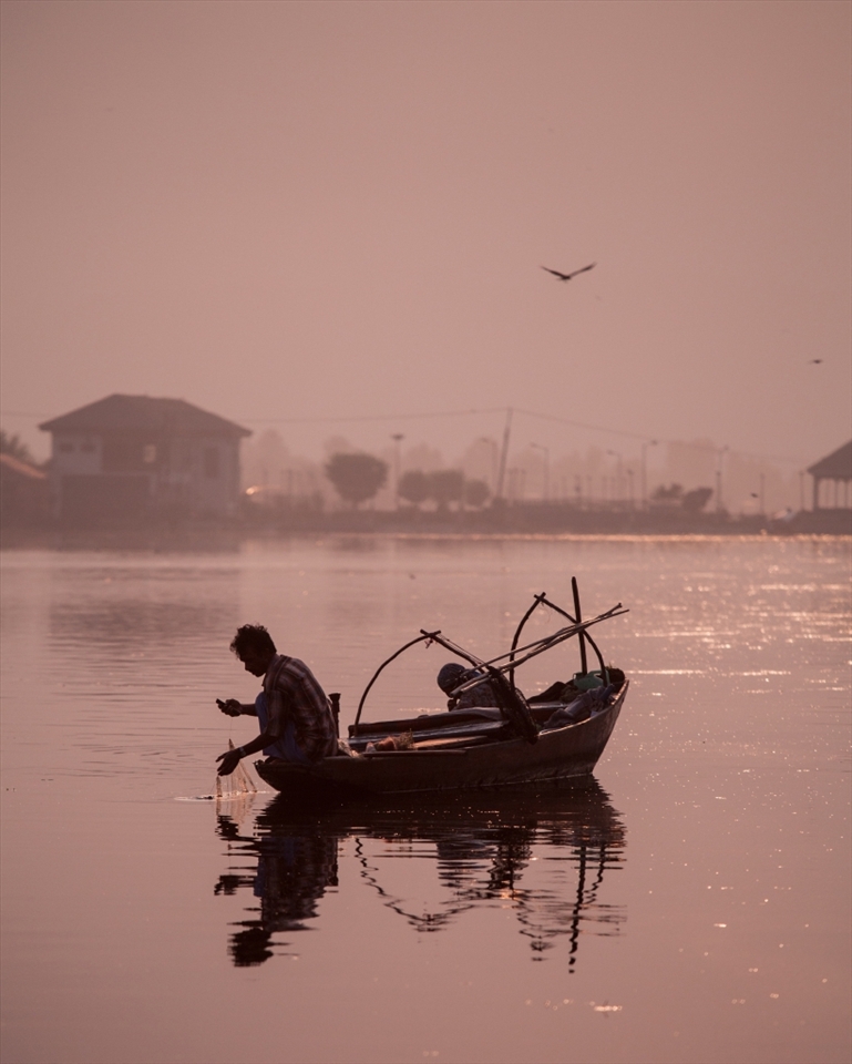 A Fishermen on the Dhal Lake, waiting for his early morning catch.