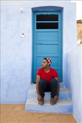 a nubian man wearing the traditional hat sitting on the roof of a nubian house: by nubia, Views[757]