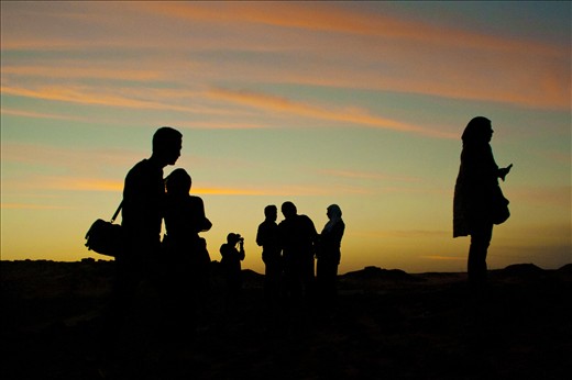 group of people at the sunset time on a hill at nubia .
