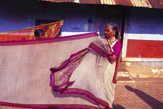 Women drying sari in the street.