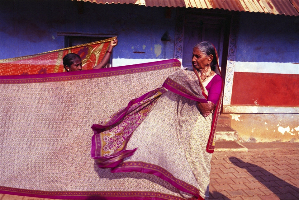 Women drying sari in the street.