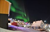 This one was taken in Upernavik, Greenland. 
I was in a hurry to go to an airport for a flight when I just suddenly caught a glimpse of a good spot to capture that moment.  The northern lights were moving in a beautiful wavy way and in addition the town was quiet, no people in streets. There was lots of Christmas lights mixed  in the town, because it was just after Christmas when I arrived there.  With everything I mentioned before, this photo is beautiful.: by oleolsvig, Views[597]