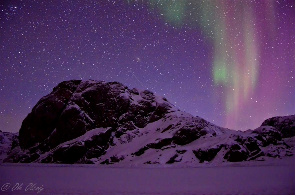 This photo was taken in high iso in winter, to capture most of the details as much as possible.
Something which is unique about this one is that the light of that night was purple, and the northern lights were beautiful mixed with shiny stars. Also as you can see in the middle, a galaxy is visible, which is probably the Andromeda galaxy as I researched about it further.
The weather is always very dry, clean and fresh in Northen Greenland, which makes it possible to see even more stars and galaxies with naked eyes.