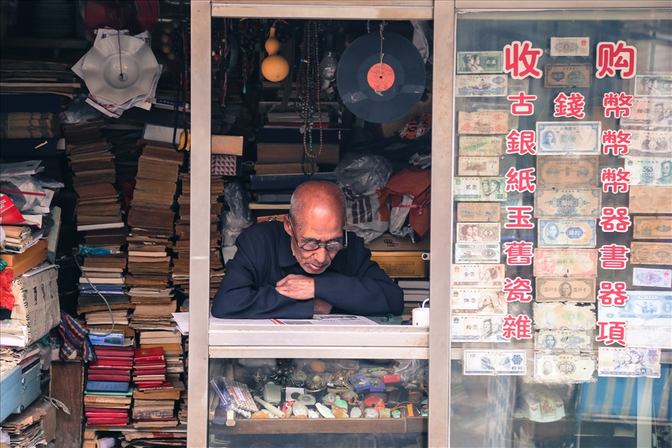 A man sitting reading in his stall full of old memorabilia in one of Tianjin’s few remaining houtongs (traditional alleyways). As a result of the cultural revolution in china a lot of ancient artefacts were lost. China has five hundred years of history and cultural wisdom to share with the world but the state of revolution the country faced has discouraged people from looking into its past. Will elements of Chinese culture and history remain hidden on dusty shelves whilst everyone is busy looking towards the future? 