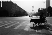 Men on bicycles cycling cross a junction with the large ‘Tianjin Eye’ looming in the background. This picture has elements of the old and new coexisting and a feeling of movement. Can China manage to move in a direction that successfully balances traditional values and the demands of a newly industrialised country?    
: by olli_stewart, Views[408]