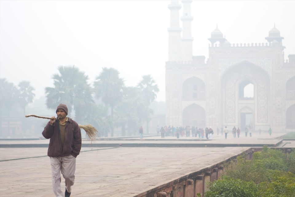 A man walks to work at the Akbar's Tomb monument in Delhi