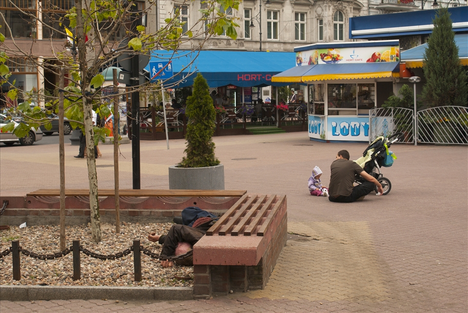 A father playing with his son regardless of the person behind him