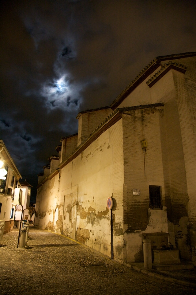 Watching the moon peek through the clouds over El Albaicin in Granada.