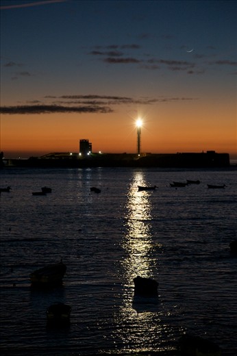 The crescent moon looming over the harbor in Cadiz.